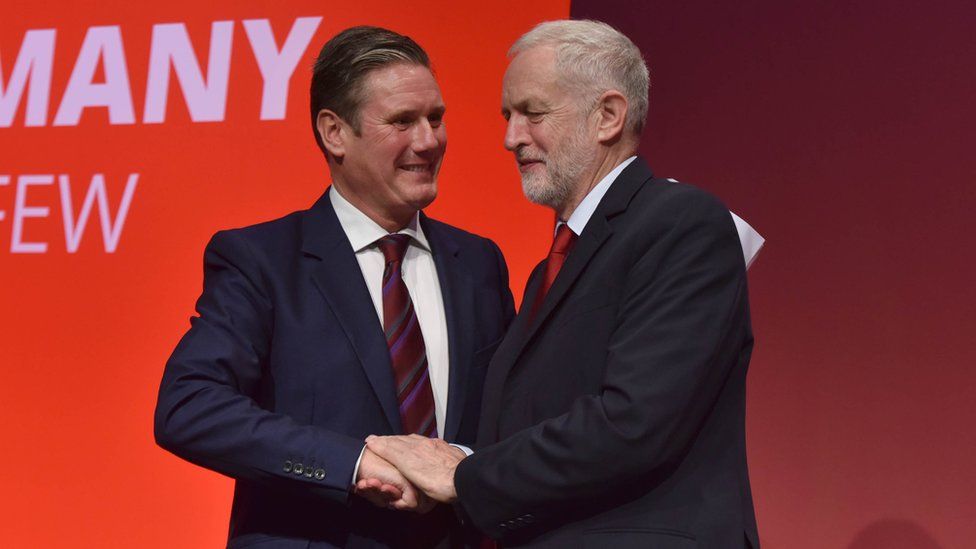 Keir Starmer and Jeremy Corbyn shake hands at the party's conference in 2017