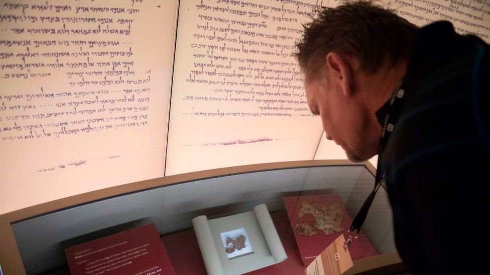 Visitors look at an exhibit about the Dead Sea scrolls during a media preview of the new Museum of the Bible