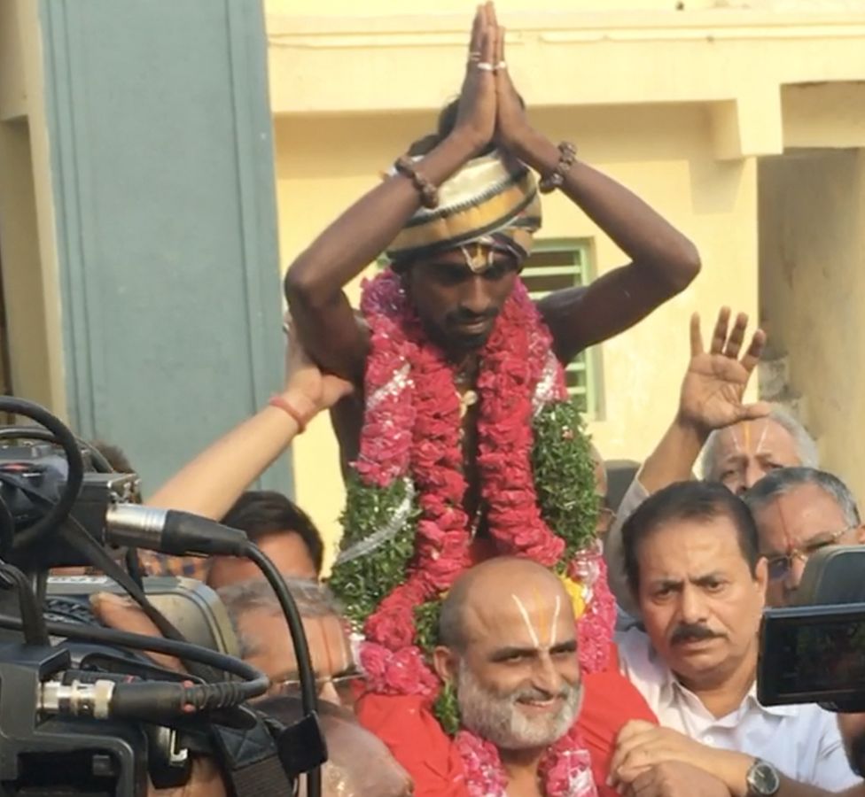 Mr Rangarajan is seen carrying Aditya on his shoulders as he enters the temple.