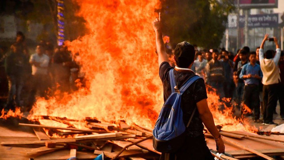 Demonstrators setup a bonfire on a street as they protest against the governments Citizenship Amendment Bill (CAB), in Guwahati on December 11, 2019.