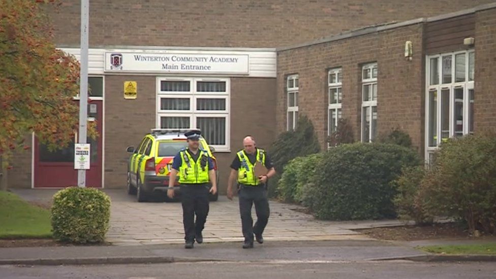 Police officers walking away from Winterton Community Academy