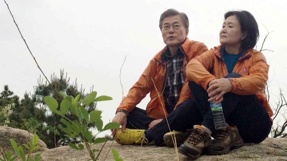 Moon Jae-in and his wife Kim Jung-sook rest on a hillside