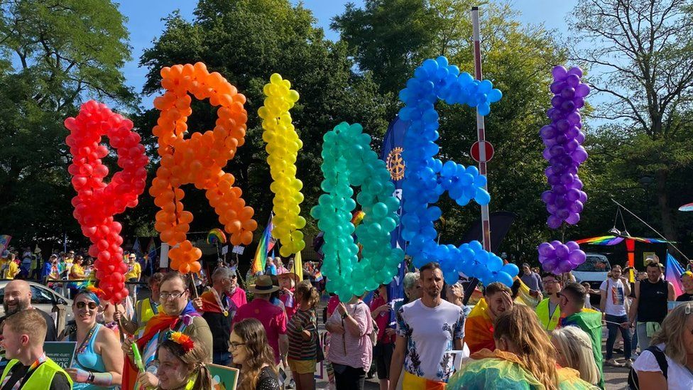 Balloons in rainbow colours spell out the word pride