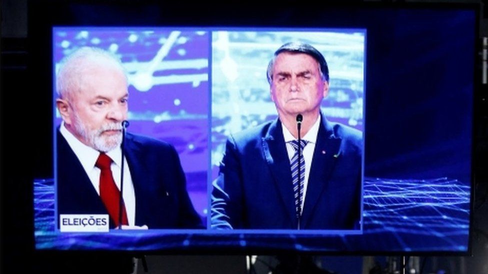 Presidential candidates Luiz Inácio Lula da Silva (left) and Jair Bolsonaro projected on a screen during the first TV debate ahead of Brazil's October general election