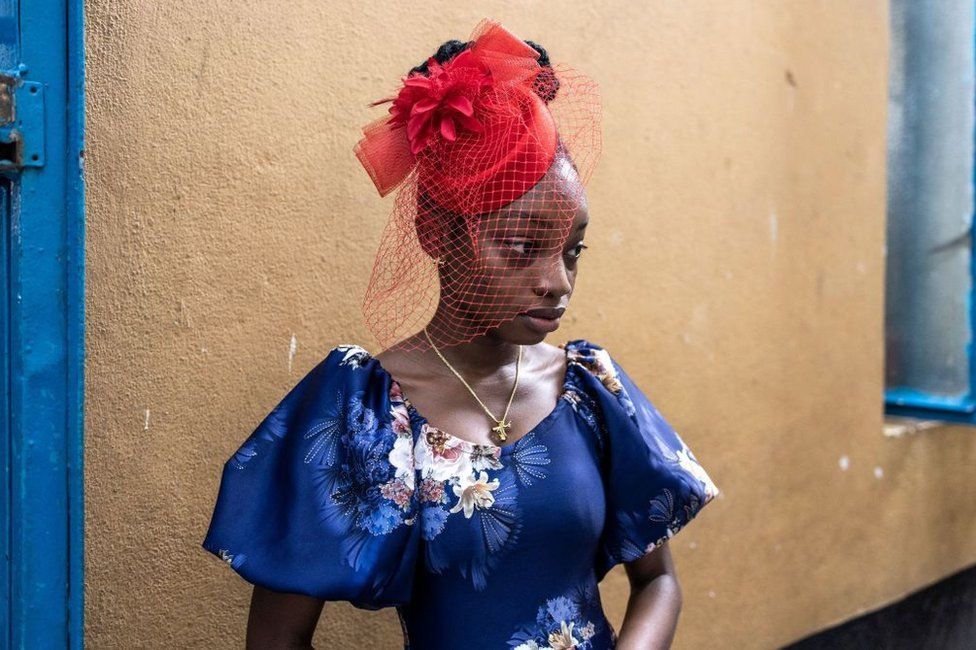 A follower of the Maroon Society and Methodist church wears a side hat ahead of an Easter Sunday service at the historic two hundred and thirty year old Zion Wilberforce Chapel in Freetown. The Maroon Church is one of the oldest churches in Sierra Leone, founded in 1808 by the Maroons. Maroons are people who were taken from present day Ghana to Jamaica as slaves but after constant rebellion were then deported to Nova Scotia, Canada and then from there around 550 were shipped to Freetown in 1800.