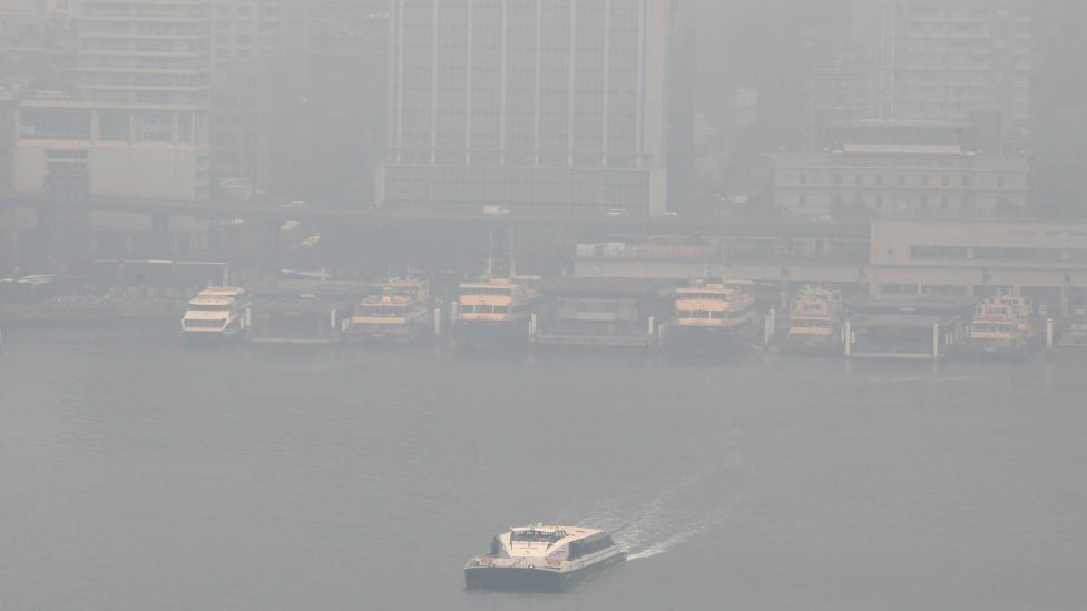 Sydney harbour ferries in the dock amid thick smoke