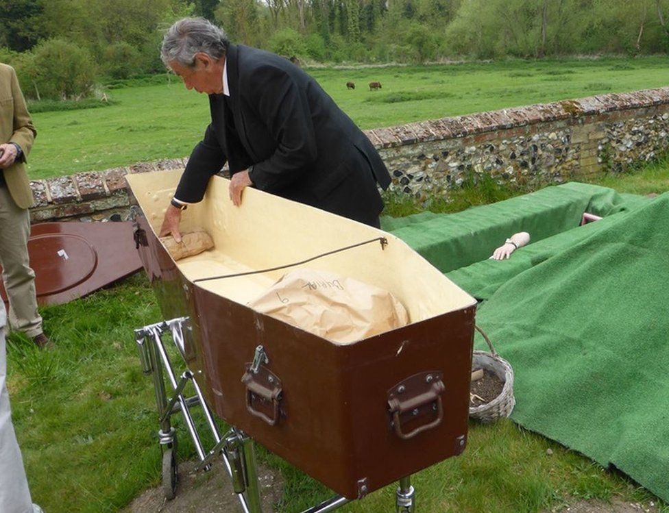 Skeletons being put in coffin