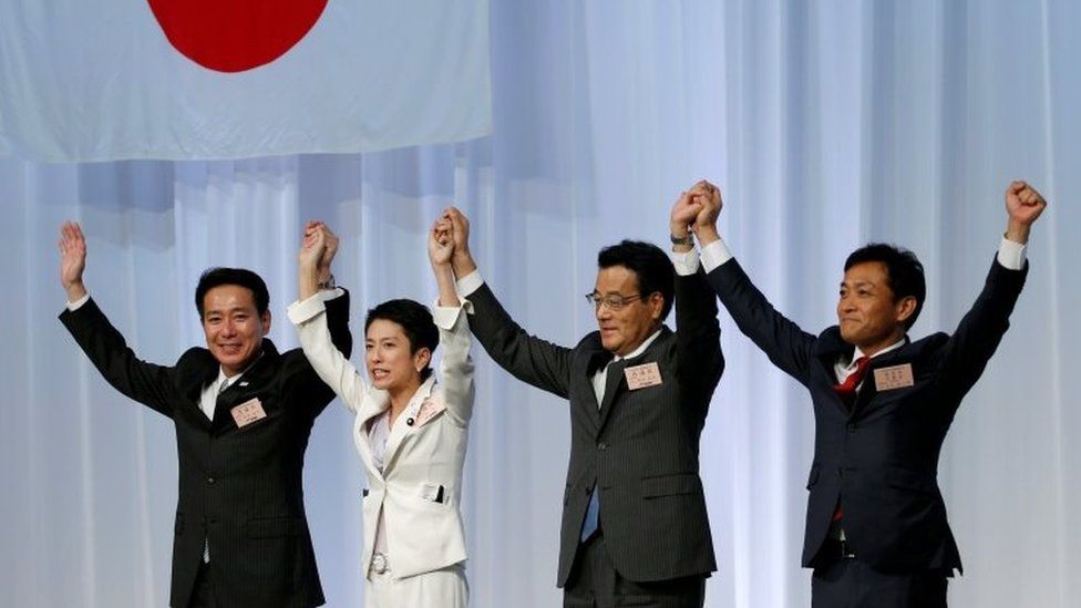 Japan"s main opposition Democratic Party"s new leader Renho (2nd L) raises her hands with her party lawmakers including former leaders Seiji Maehara (L) and Katsuya Okada (2nd R) after she was elected party leader at the party plenary meeting in Tokyo, Japan September 15, 2016.