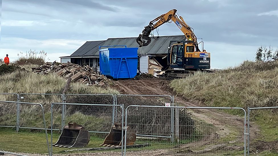 Claw digger demolishes wooden home on The Marrams in Hemsby, Norfolk