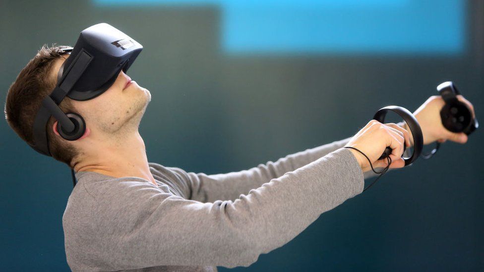 A man playing a virtual reality mountain climbing video game