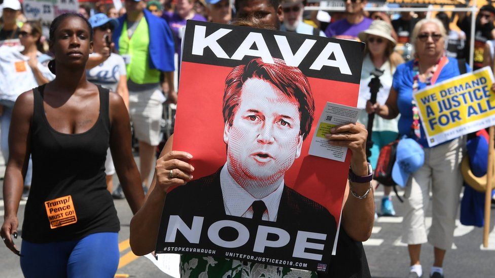 Demonstrators march through the city streets during the "Unite For Justice" rally in protest of judge Brett Kavanaugh"s confirmation