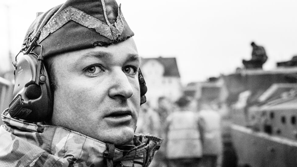 C Squadron Leader of The Queen's Royal Hussars supervising loading of his tanks on to railway flats at Sennelager railhead, Germany, 2019