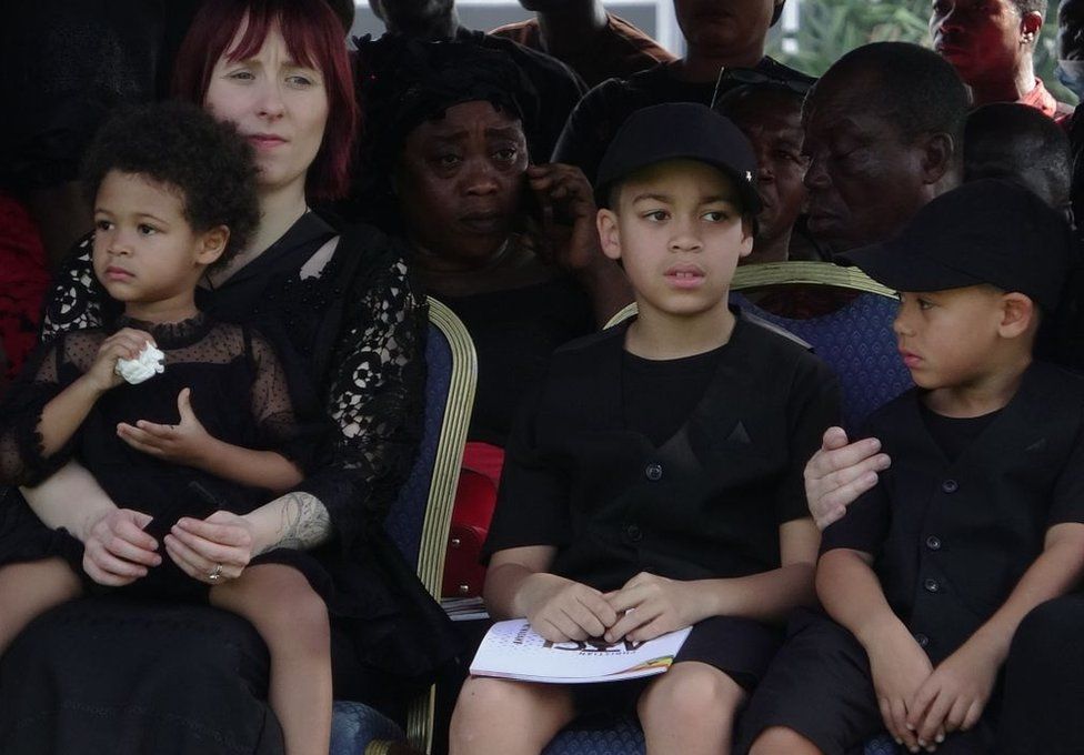 Christian Atsu's widow, Marie-Claire Rupio, with their children.