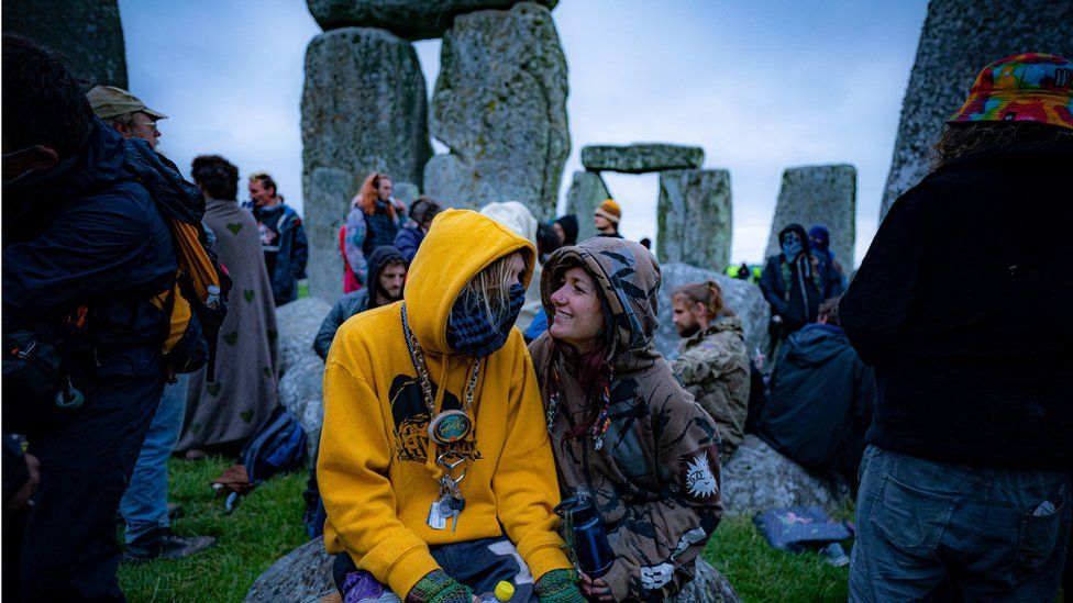 People inside the stone-circle during Summer Solstice at Stonehenge, where some people jumped over the fence to enter the site to watch the sun rise at dawn of the longest day in the UK. The stones have been officially closed for the celebrations, which see huge crowds inside the circle, due to the coronavirus lockdown extension.
