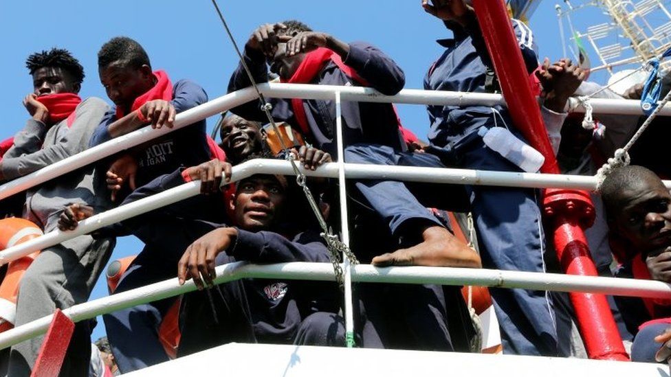 Migrants wait to disembark as they arrive at the Crotone harbour, Italy. Photo: 21 June 2017