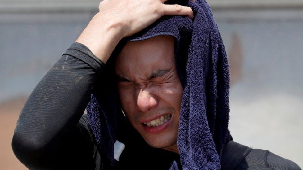 A volunteer for recovery work wipes his sweat in Okayama Prefecture, 14 July 2018