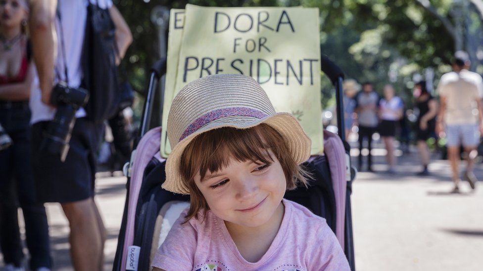 A young child, before a sign saying "Dora for President" attends an anti-U.S. President Donald Trump protest on January 21, 2017 in Sydney, Australia