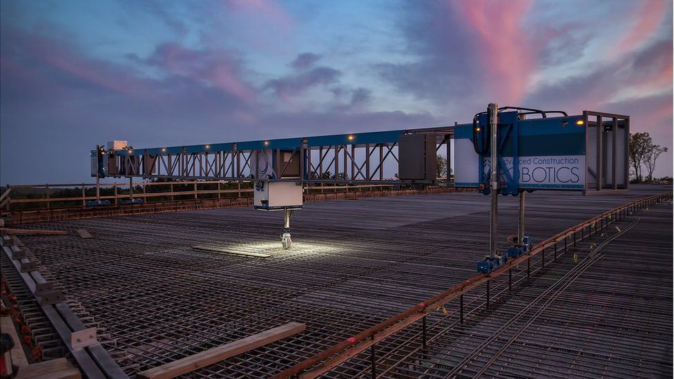 TyBot starting construction at night on a bridge
