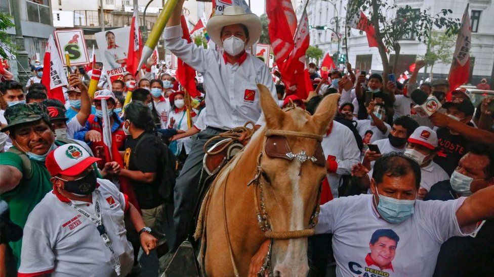 Peruvian presidential candidate for the radical leftist party Peru Libre (Free Peru), Pedro Castillo, rides a horse holding a giant pencil during the closing rally of his campaign in Lima on April 8, 2021