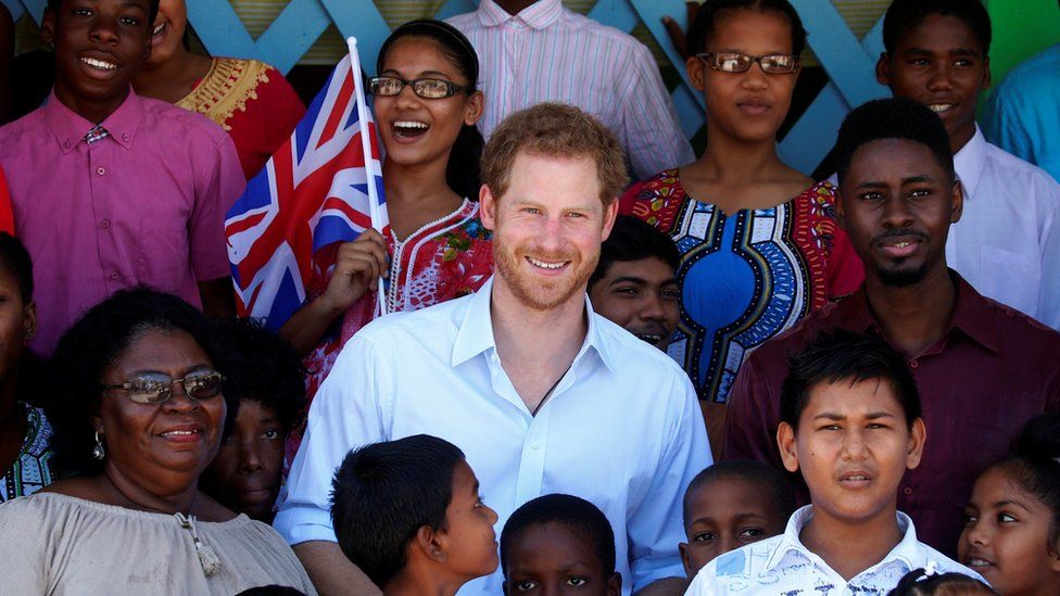 Prince Harry poses for a photo with some of the children at Joshua House Children's Center in Georgetown, Guyana