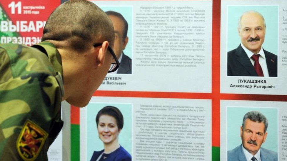 A Belarus soldier looks at the candidates list during presidential elections at a polling station in Bogushi in Minsk (11 October 2015)