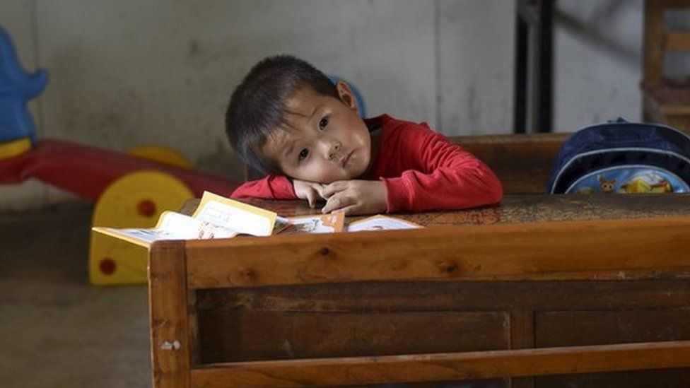 A student rests his head on a table inside a classroom of Dalu primary school in Gucheng township of Hefei, Anhui province, China, 8 September 2015.