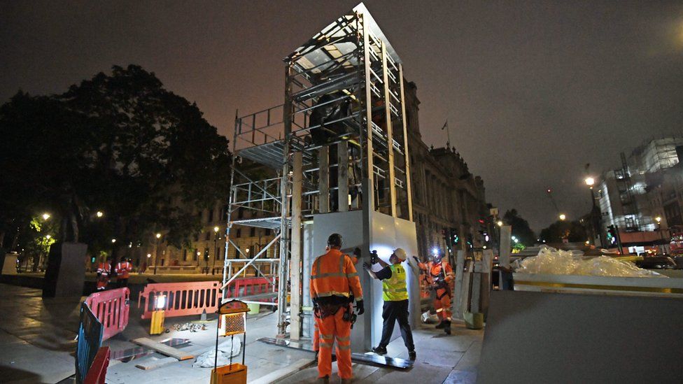 Scaffolders erect boarding around the statue of Sir Winston Churchill in Parliament Square, London