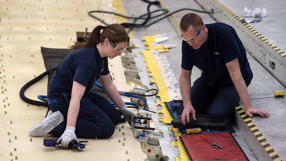 Airbus employees construct a wing for an Airbus A350 aircraft at Airbus' wing production plant near Broughton in north-east Wales