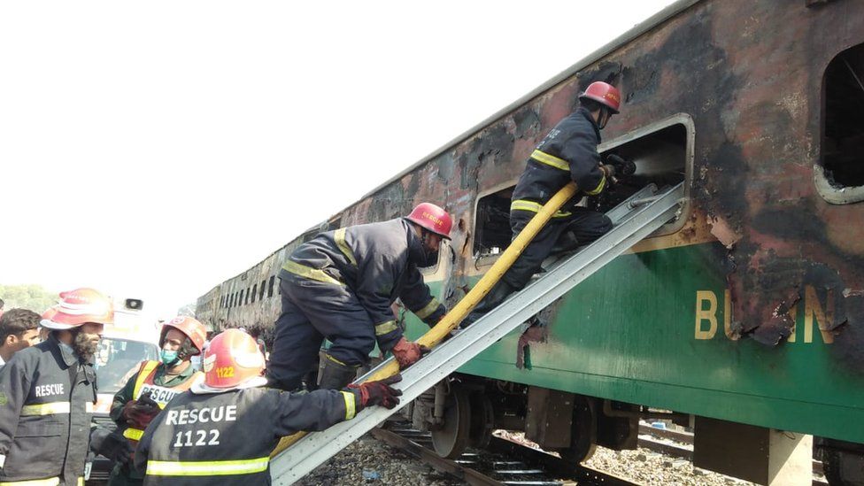 Pakistan firemen board the train that was set alight on 31 October