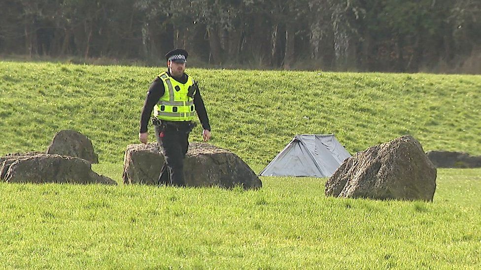 A body was found on a football pitch in Motherwell - the site is now covered by a small white forensics tent