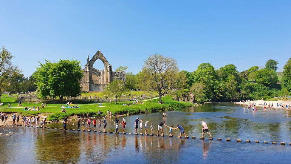 People enjoy the sunshine at Bolton Abbey in Yorkshire on Bank Holiday Monday