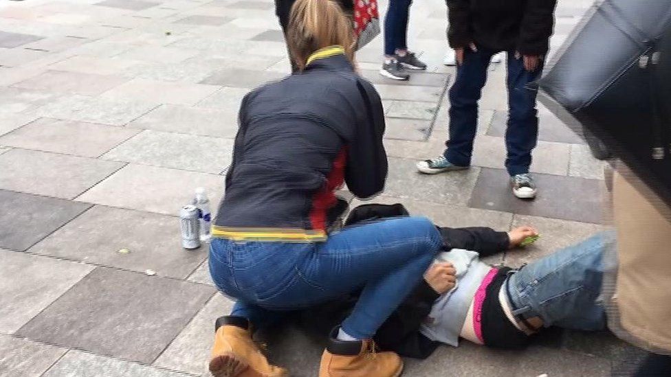 Spice user lying on ground in Cardiff