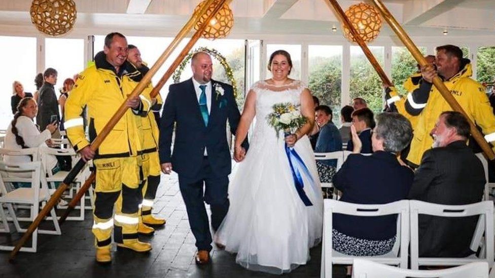 RNLI crew members with the bride and groom