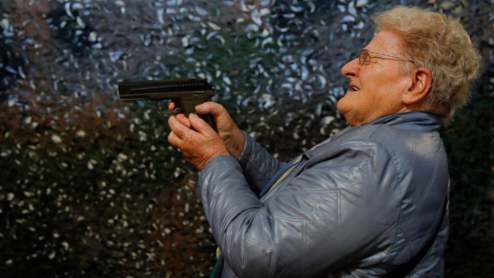A visitor tries out a CO2 air pistol during the 45th edition of the Arms Trade Fair in Lucerne, Switzerland on 29 March, 2019