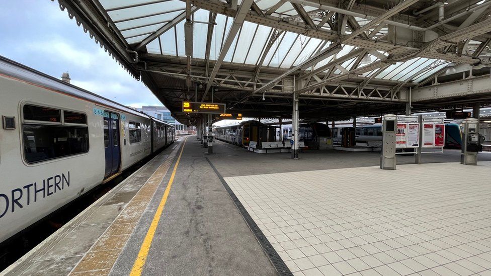 A train at Sheffield station waiting at an empty platform