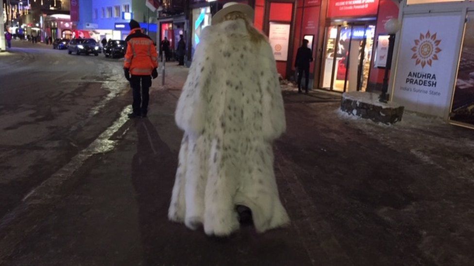 Rear view of someone in Davos wearing a fur coat