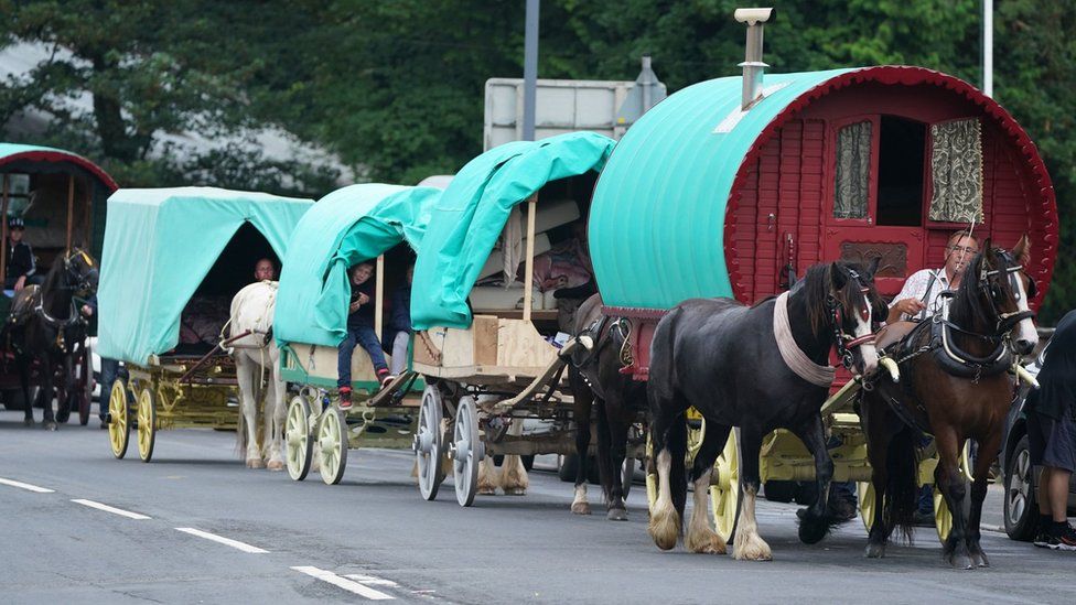 A convoy of horse drawn wagons arrive in Appleby, Cumbria, ahead of the annual Horse Fair