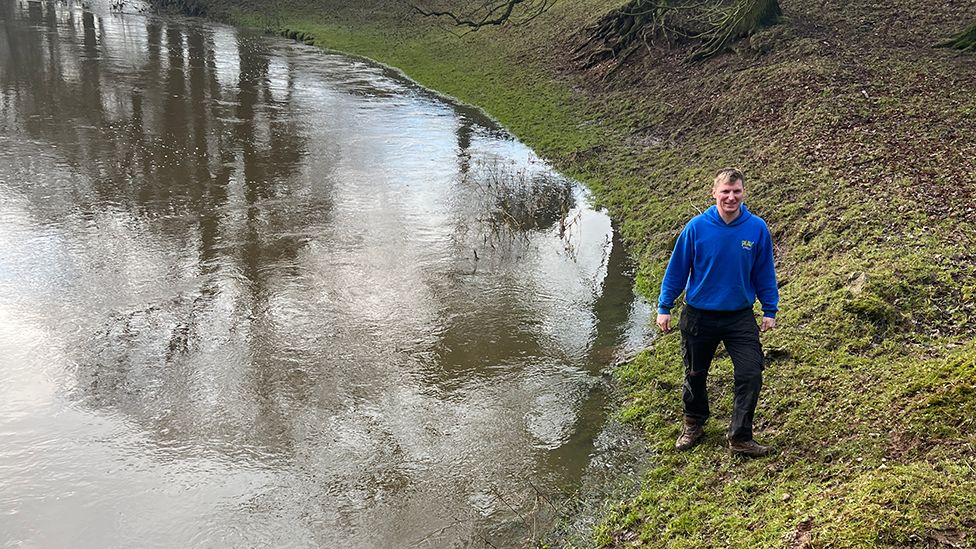 Richard Bower next to flooded land