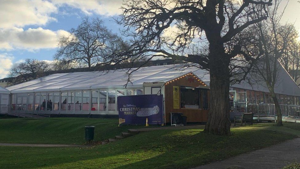 Cheltenham ice rink on a winter day with a Christmas market banner outside