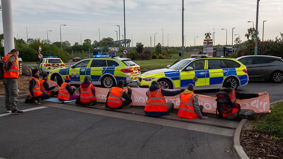 Police arrive on the scene as activists from Just Stop Oil target a Shell Petrol station on the M25 motorway on April 28, 2022 in Cobham, England