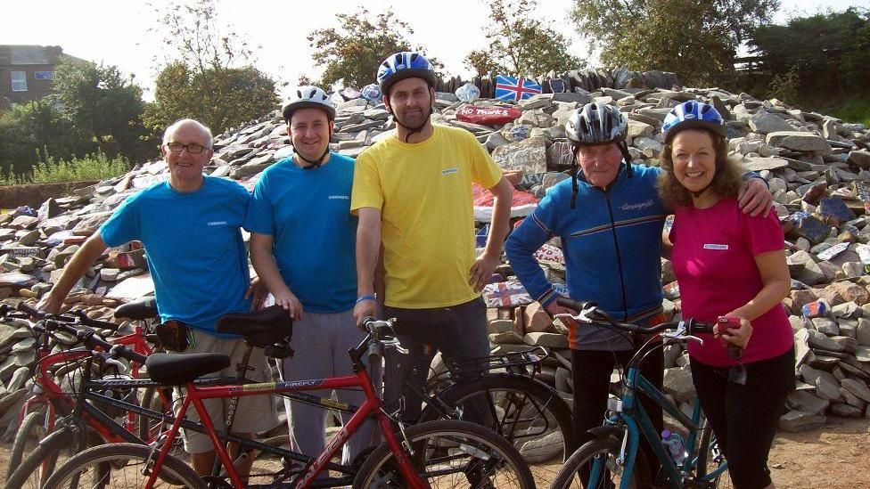 The No Borders Bike Team at the cairn in 2014