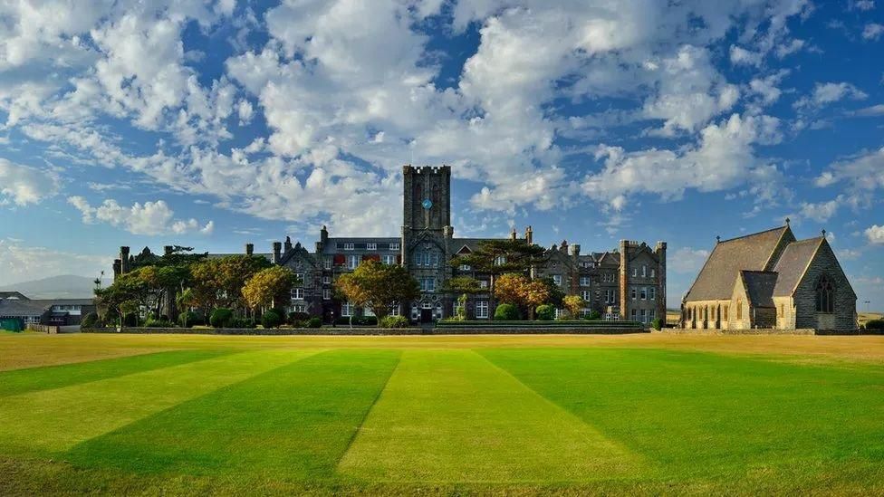 The old grand looking school with a tower in the middle