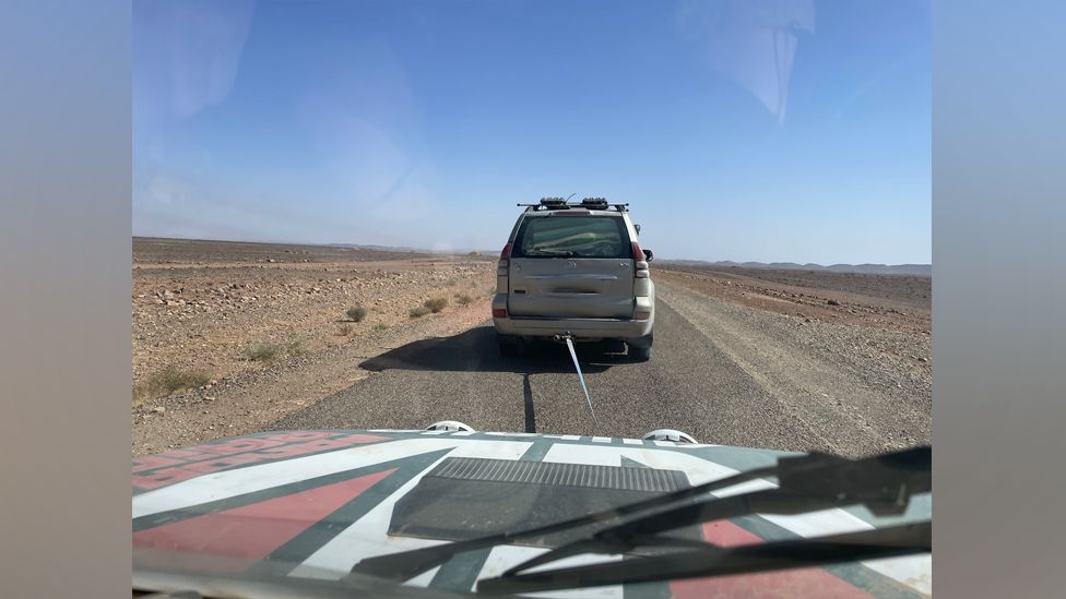 The Fiat Panda being towed by another car in the desert