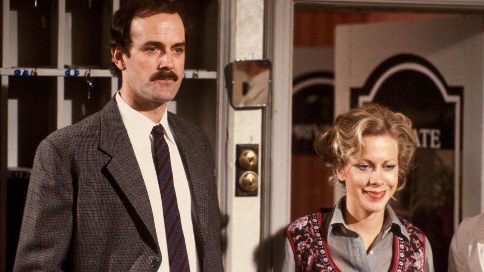 John Cleese as Basil Fawlty and Connie Booth as Polly 