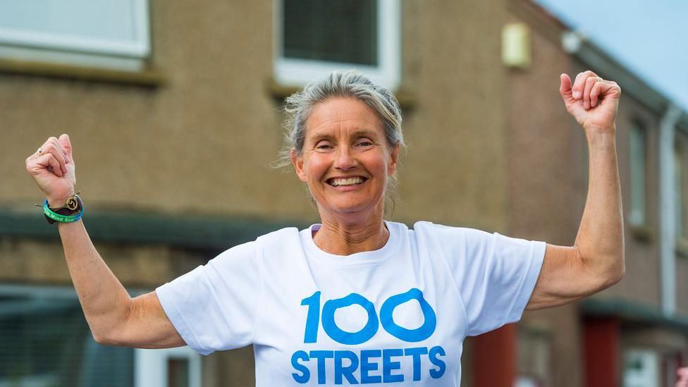 jennifer hastings in a 100 Streets T shirt