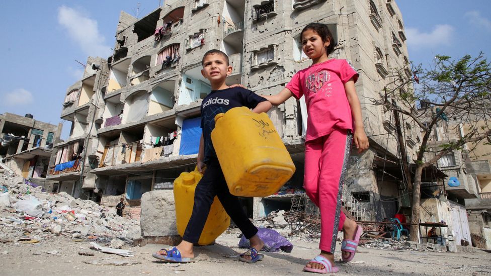 Palestinian children walk past a house damaged in an Israeli strike, amid the ongoing conflict between Israel and the Palestinian Islamist group Hamas, in Rafah, in the southern Gaza Strip, May 1, 2024.