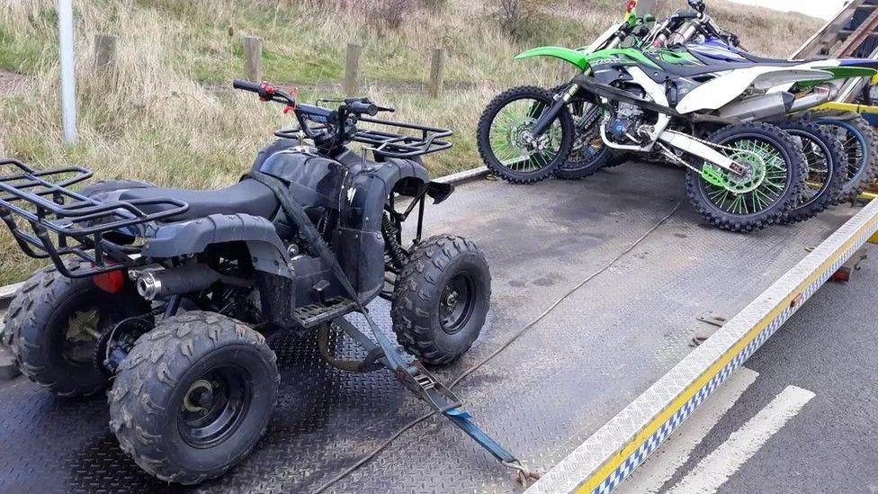 Quad bikes and off road bikes on a lorry