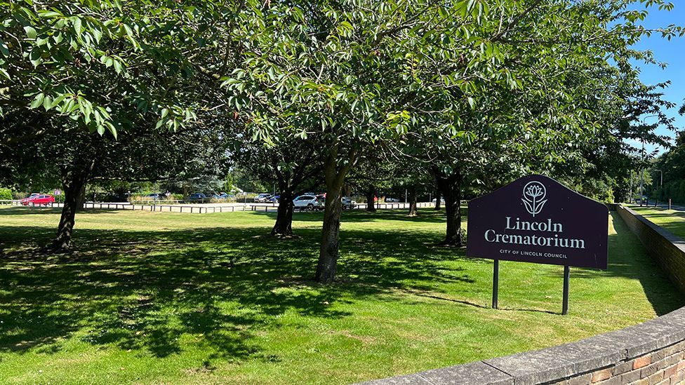 A view of the outside of Lincoln Crematorium with the entrance sign in the foreground