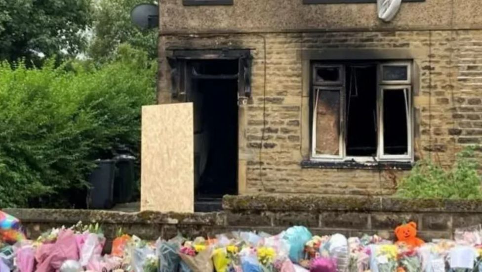 Floral tributes at the family's home on Westbury Road in Bradford