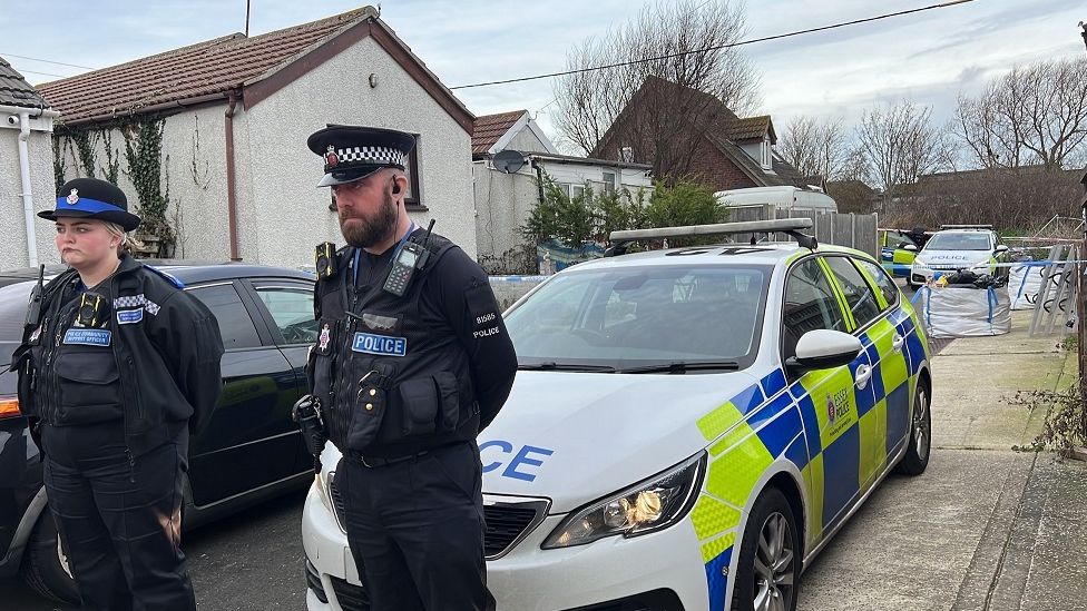 Police officers guard a cordon in Hillman Avenue, Jaywick